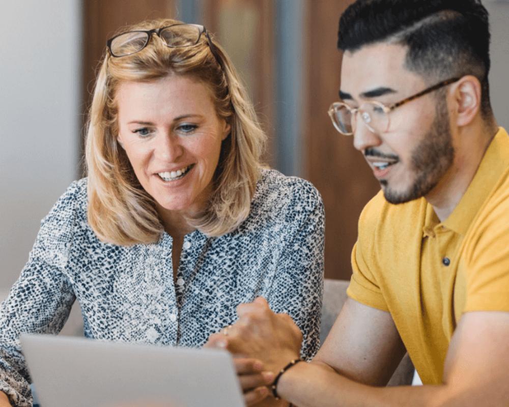 Man and woman sitting at computer