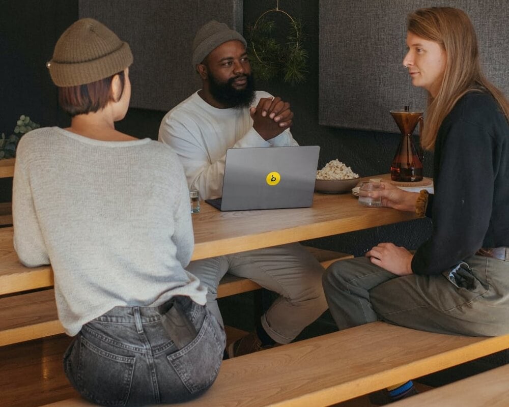 Three people sitting at a table