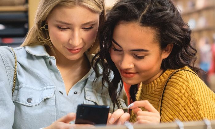 Two woman looking at mobile phone