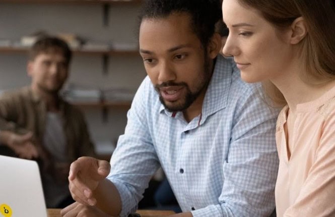 Man and woman looking at laptop screen